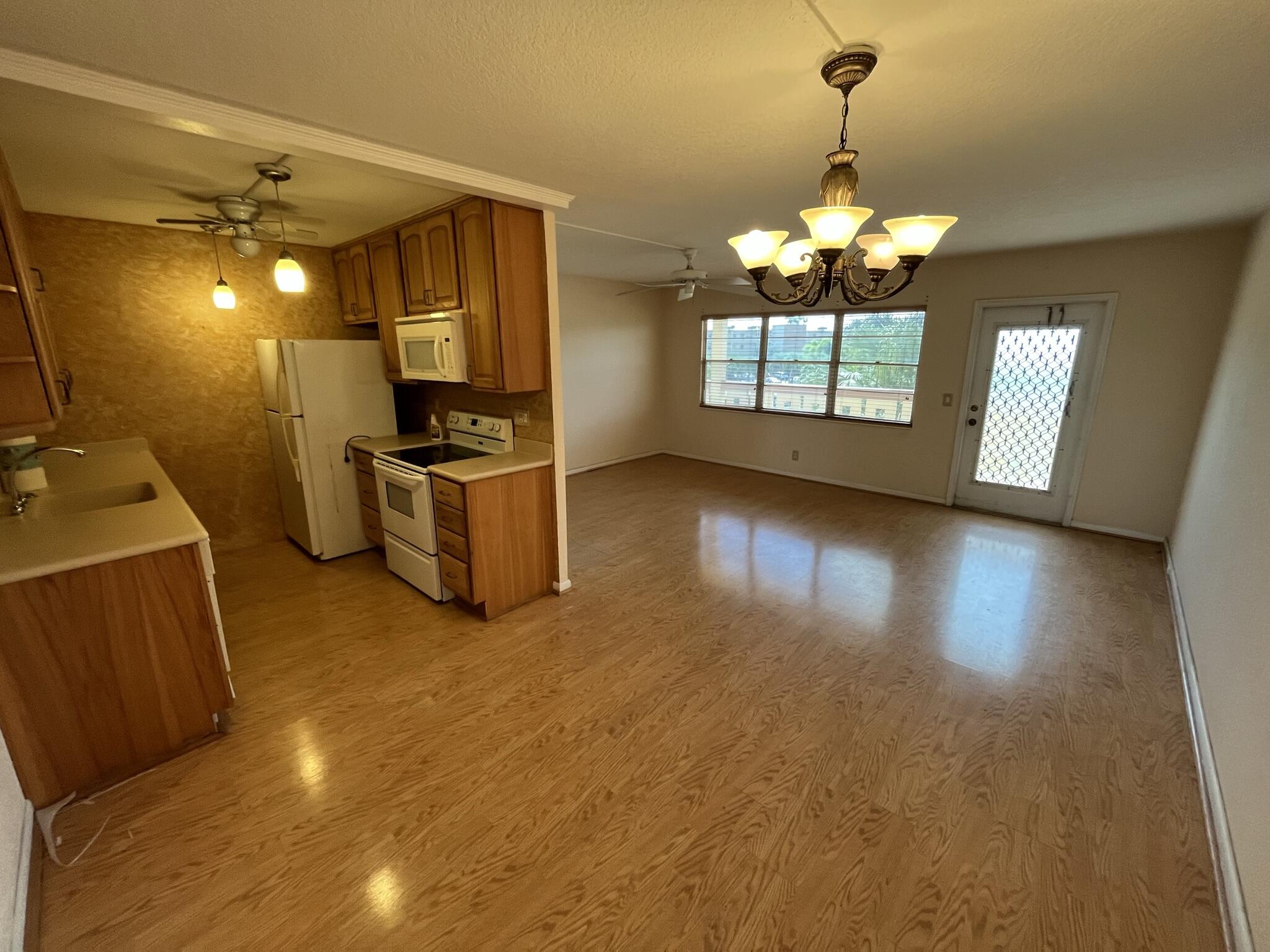 3013 Newcastle A Boca Raton, FL 33434 - Photo 5 of 19 a view of a kitchen with a sink dishwasher and fireplace