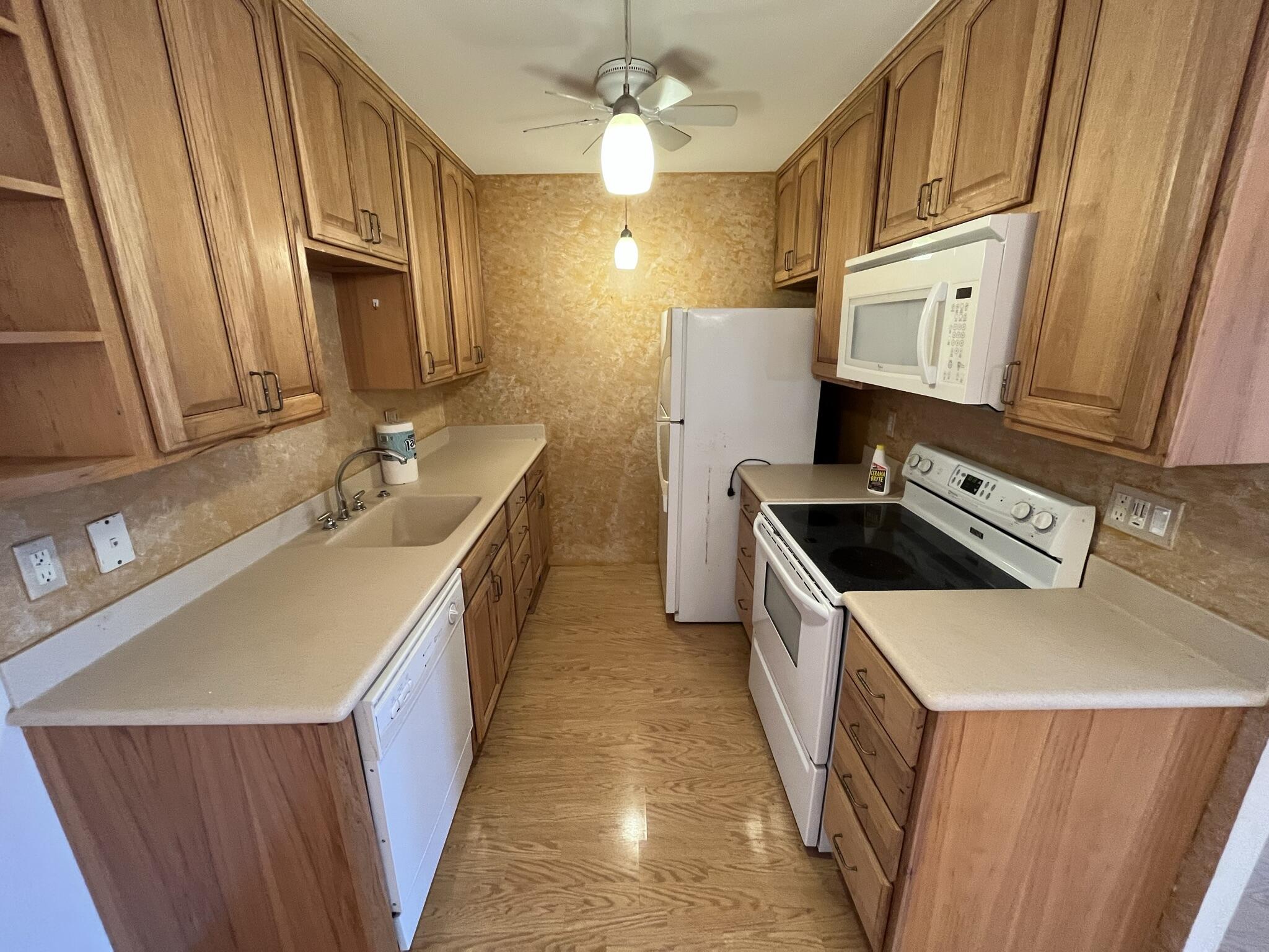 3013 Newcastle A Boca Raton, FL 33434 - Photo 6 of 19 a kitchen with a sink stove and cabinets