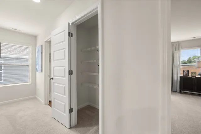 a spacious bedroom with a bed and a painting on the wall