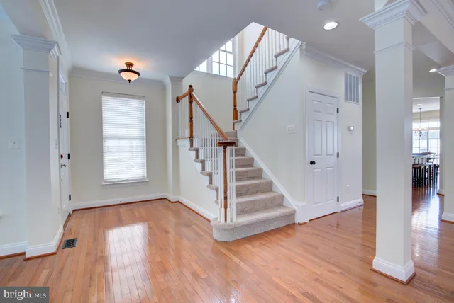 a view of entryway and hall with wooden floor