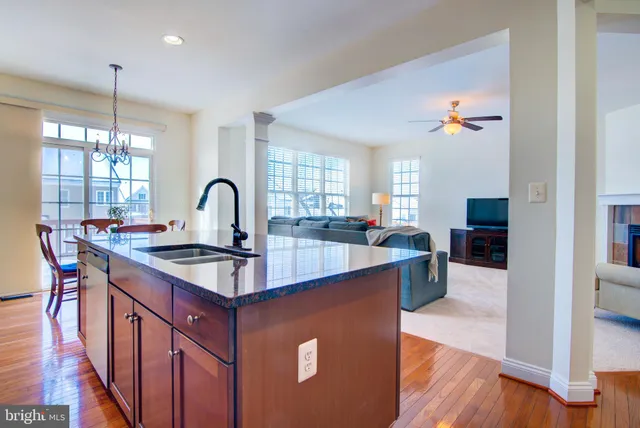 a kitchen with kitchen island a sink stove and wooden floor