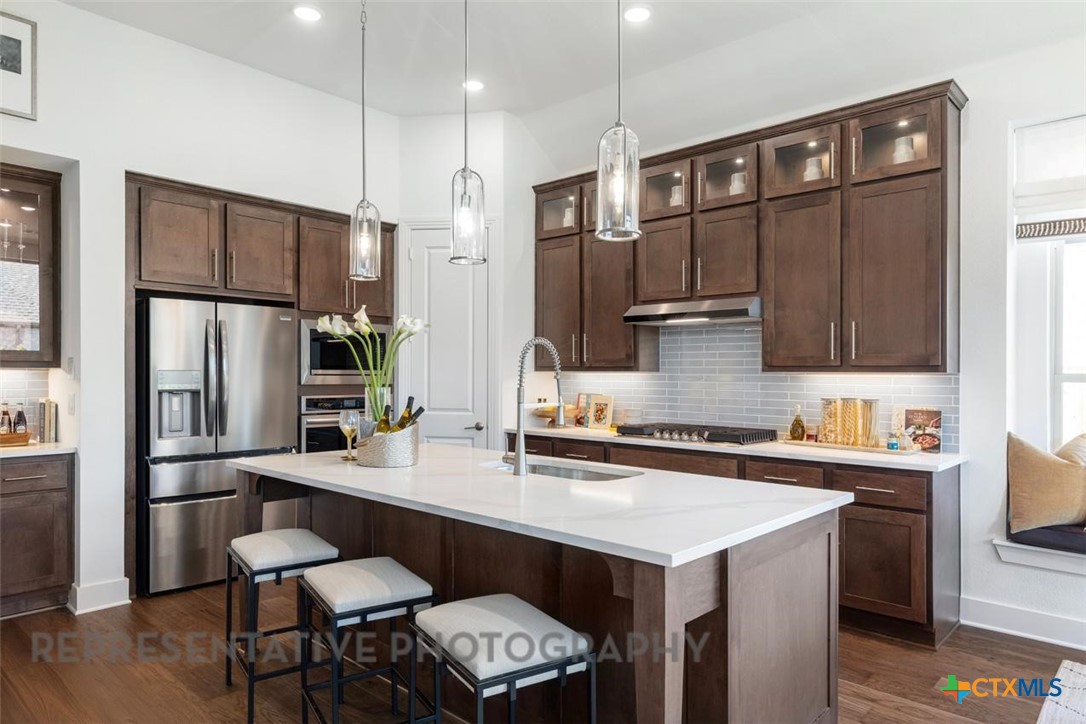 148 Pigeon River Road Kyle, TX 78640 - Photo 2 of 40 a kitchen with stainless steel appliances a sink cabinets and refrigerator