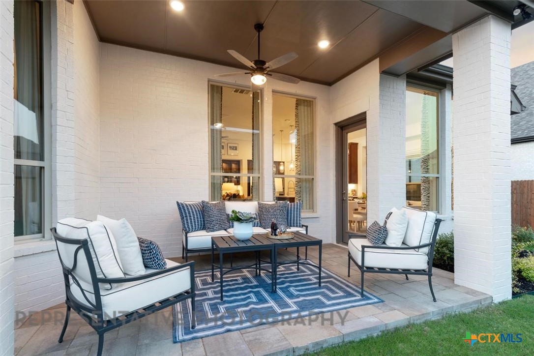 148 Pigeon River Road Kyle, TX 78640 - Photo 34 of 40 a living room with furniture and a chandelier