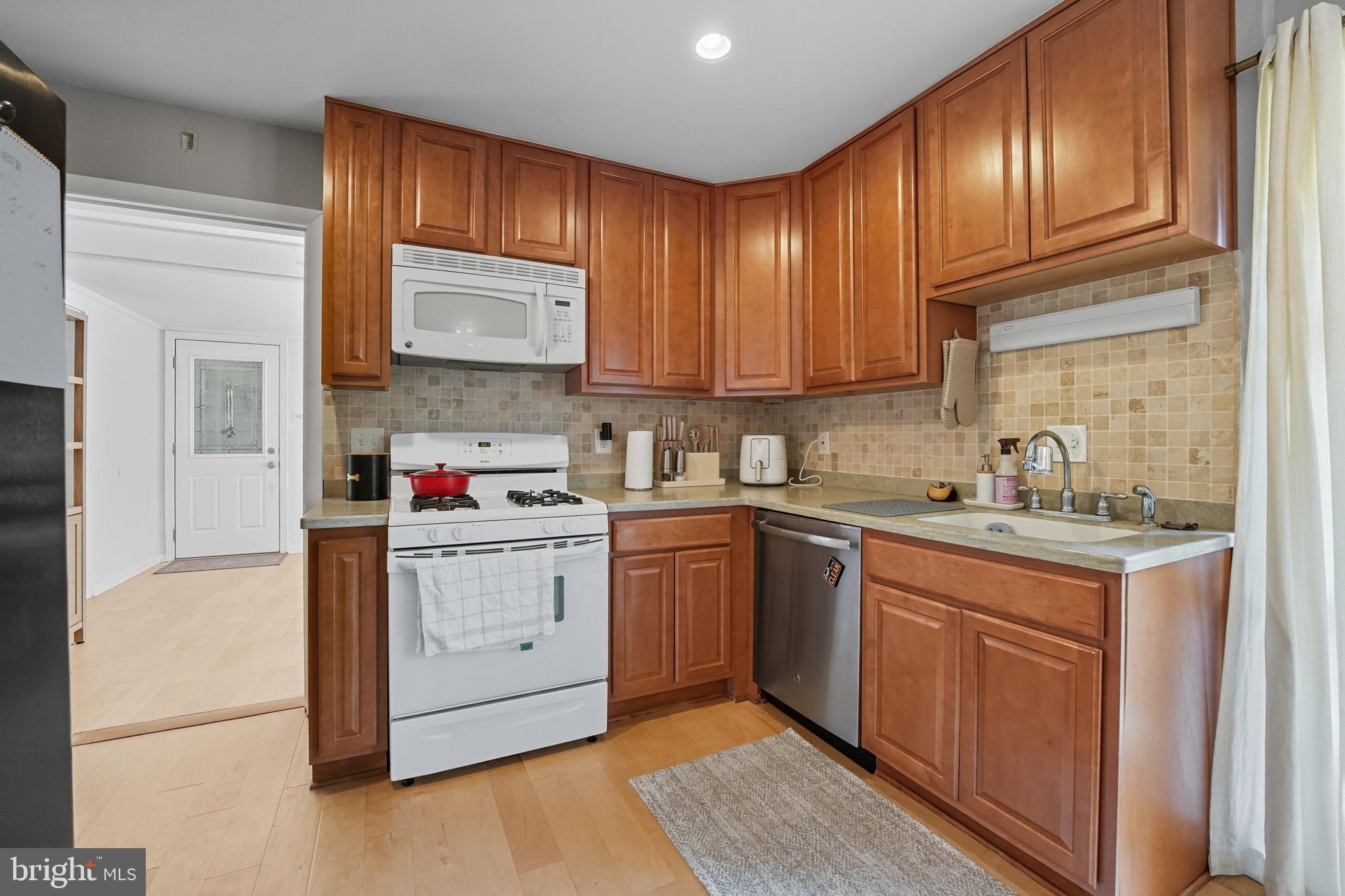 7317 Floyd Avenue Springfield, VA 22150 - Photo 16 of 33 Charming kitchen with warm wood cabinetry.