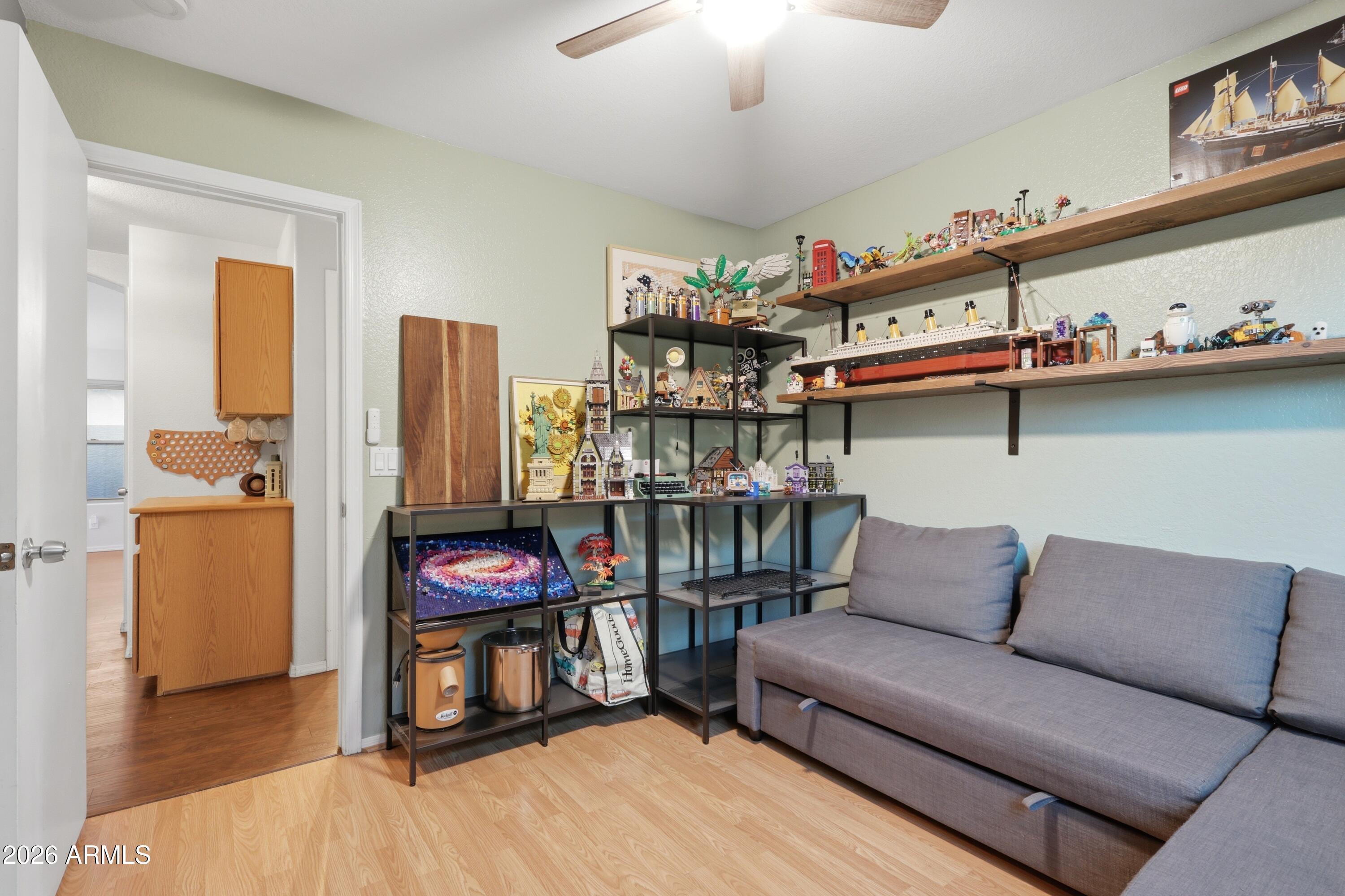661 North Joshua Tree Lane Gilbert, AZ 85234 - Photo 21 of 47 a living room with furniture a flat screen tv and a table