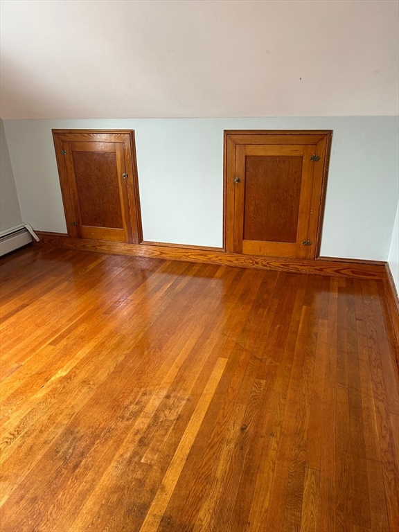 a view of an empty room and wooden floor