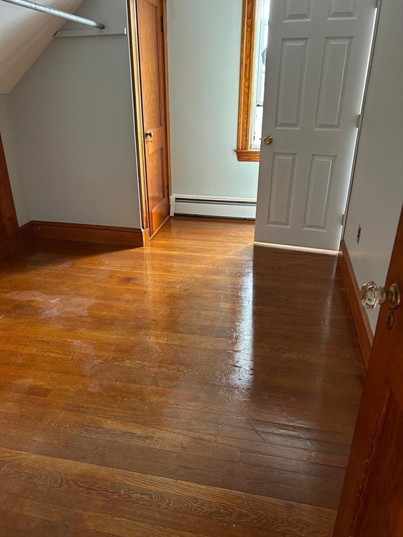 21 Wilson Street, Unit 3 Salem, MA 01970 - Photo 11 of 14 a view of an empty room with wooden floor and a window