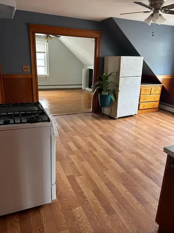 a view of a room with wooden floor