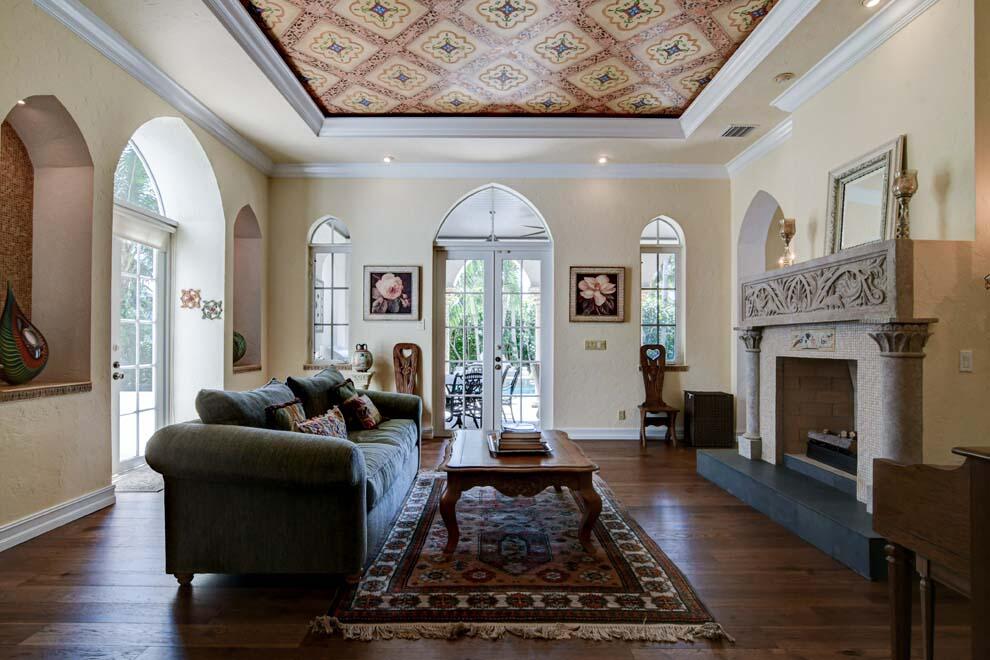 1054 Melaleuca Road Delray Beach, FL 33483 - Photo 11 of 26 a living room with furniture a fireplace and a table