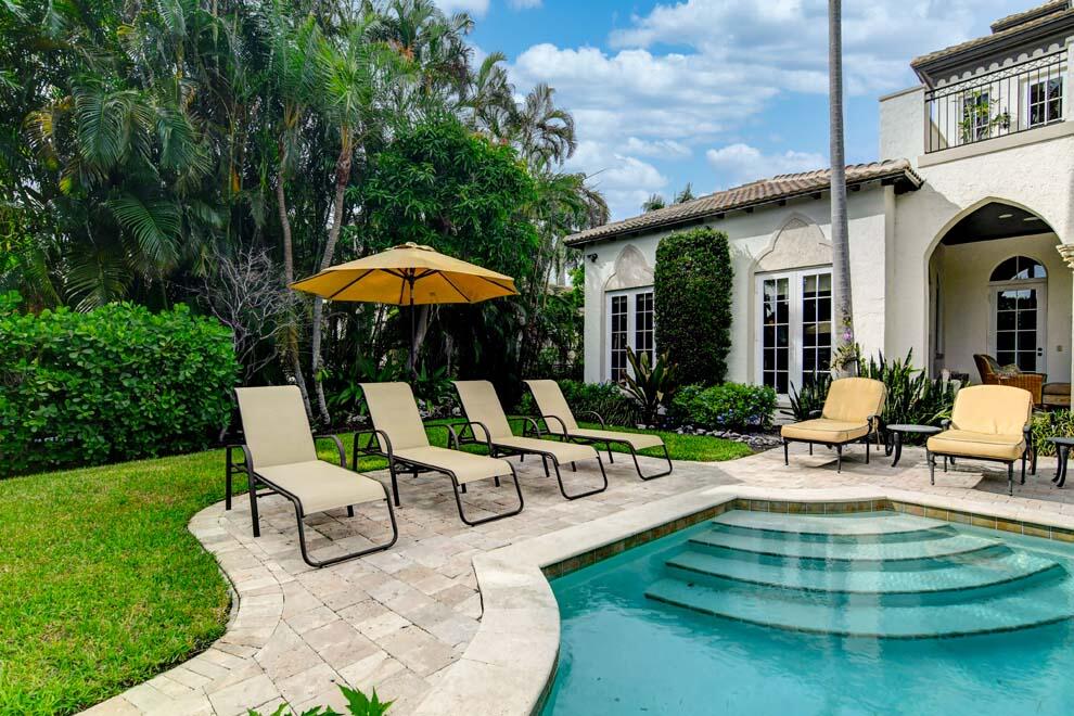 1054 Melaleuca Road Delray Beach, FL 33483 - Photo 14 of 26 a view of a patio with a table chairs and a small yard