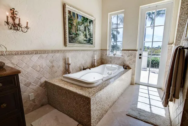 a bathroom with a tub sink and window