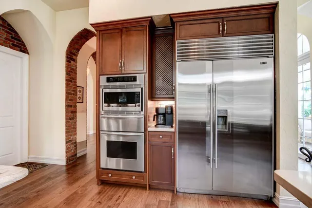 a kitchen with a refrigerator and an oven