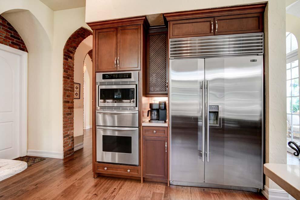 1054 Melaleuca Road Delray Beach, FL 33483 - Photo 7 of 26 a kitchen with a refrigerator and an oven