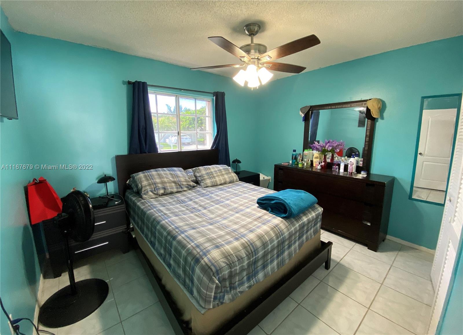 West Kendall Miami, FL 33193 - Photo 12 of 15 a bedroom with a bed and a chandelier