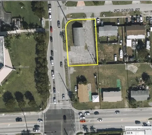 an aerial view of a residential houses with outdoor space