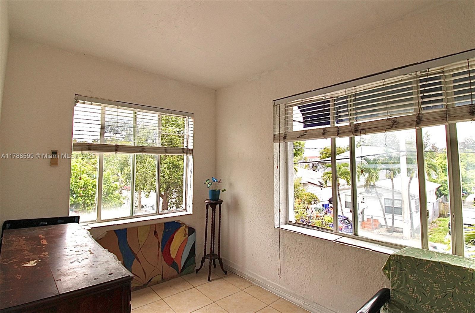 1021 Northwest 3rd Street, Unit 201 Miami, FL 33128 - Photo 14 of 27 a view of an empty room with wooden floor and a window