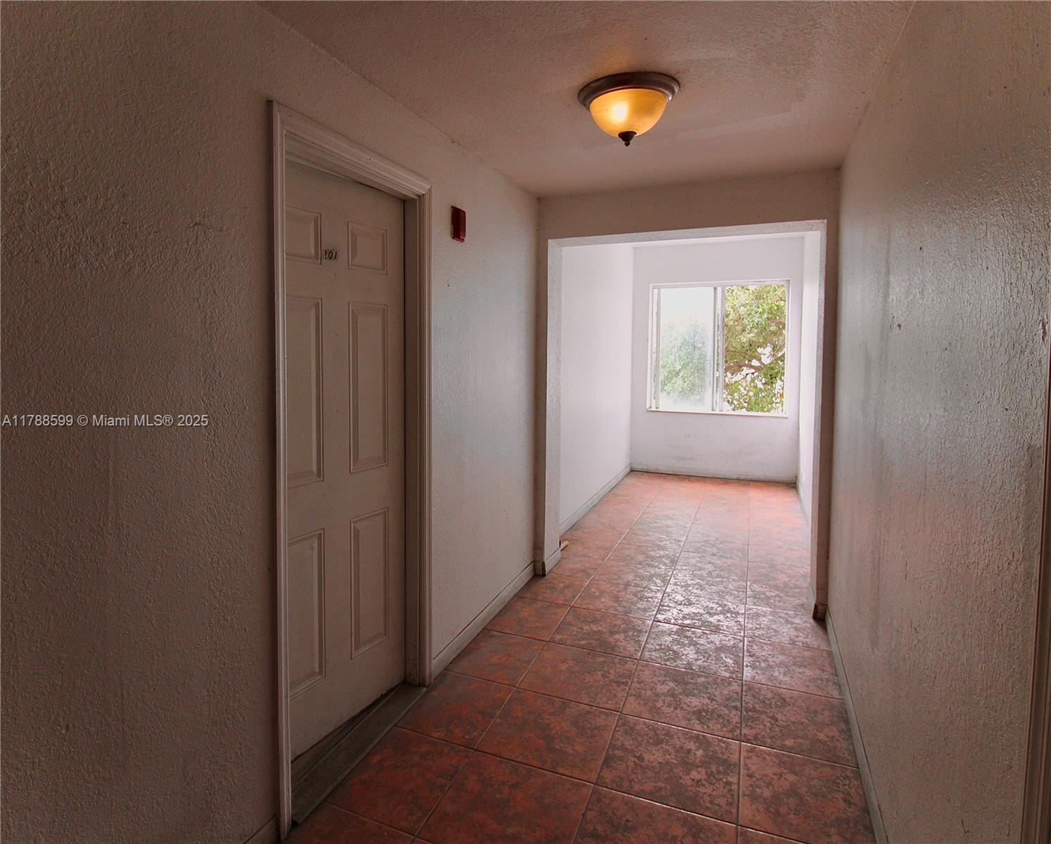 1021 Northwest 3rd Street, Unit 201 Miami, FL 33128 - Photo 17 of 27 a view of hallway with a door and a window