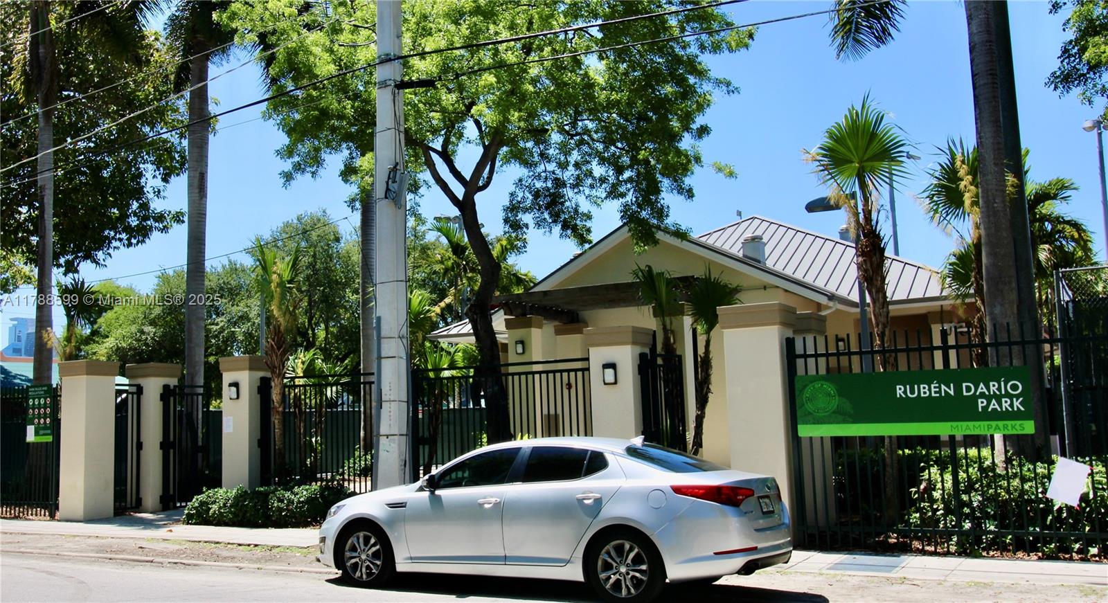 1021 Northwest 3rd Street, Unit 201 Miami, FL 33128 - Photo 19 of 27 a car parked in front of a house with a yard