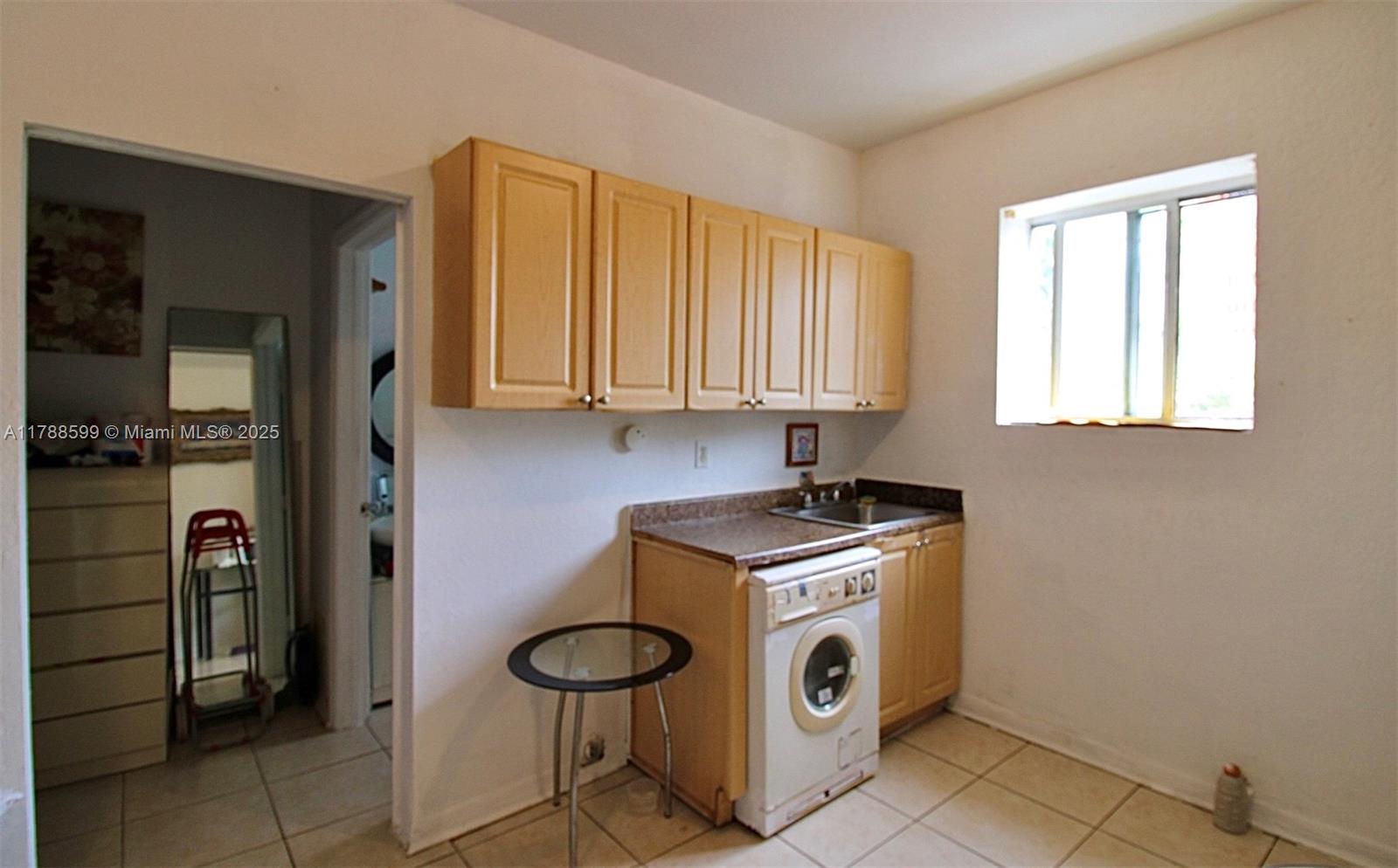 1021 Northwest 3rd Street, Unit 201 Miami, FL 33128 - Photo 5 of 27 a utility room with dryer and washer