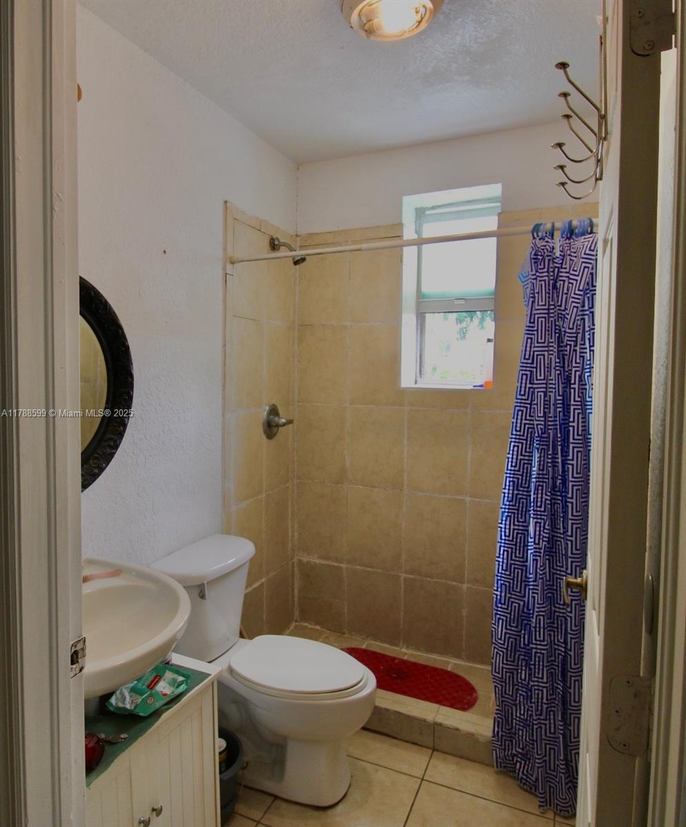 1021 Northwest 3rd Street, Unit 201 Miami, FL 33128 - Photo 6 of 27 a bathroom with a toilet and a shower