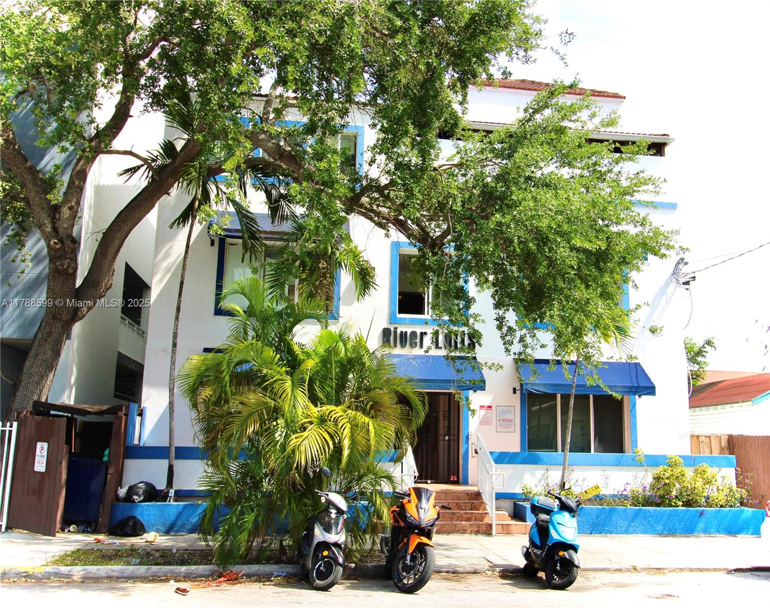 1021 Northwest 3rd Street, Unit 201 Miami, FL 33128 - Photo 10 of 27 a front view of a house with a tree