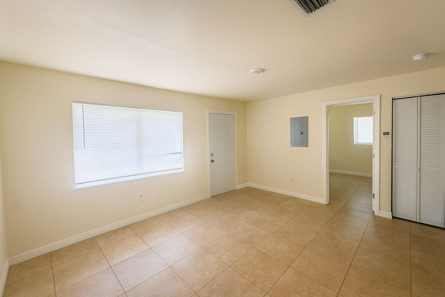 908 Mccray Court, Unit A Fort Pierce, FL 34950 - Photo 2 of 6 a view of an empty room with a window