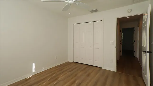 a view of an empty room with a fan