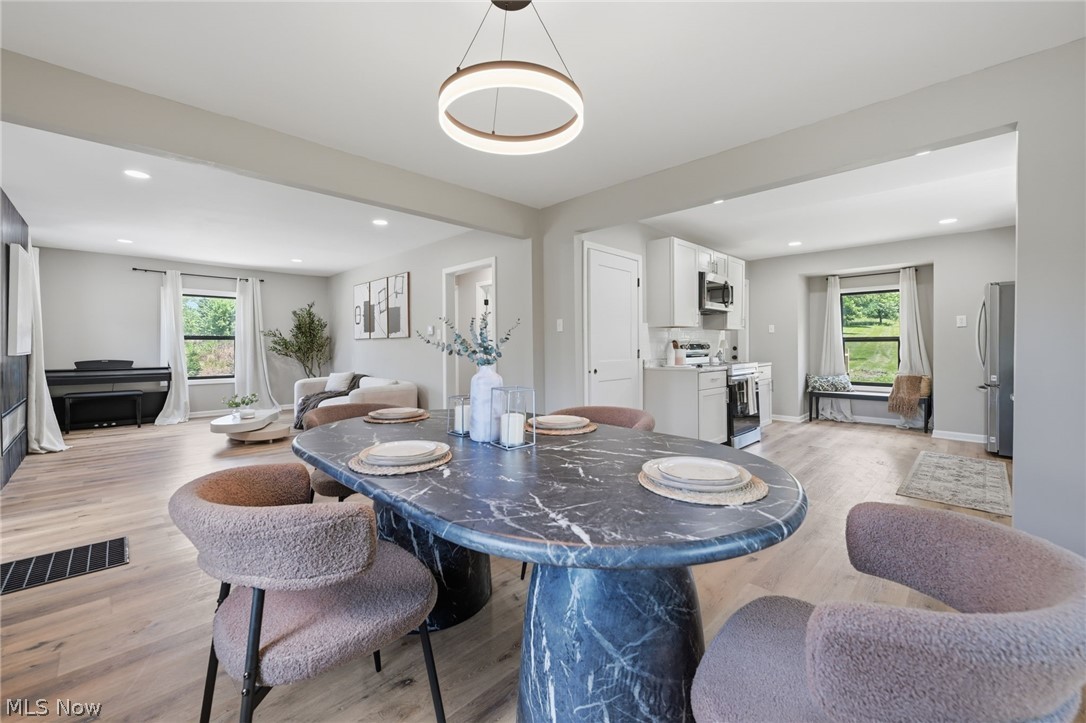 951 Bey Road Akron, OH 44312 - Photo 10 of 34 Open-concept dining area featuring a distinctive marble-look dining table and a contemporary circular chandelier