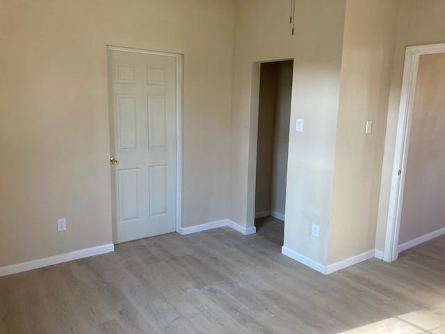 608 Turner Street Waco, TX 76704 - Photo 8 of 14 an empty room with wooden floor and closet
