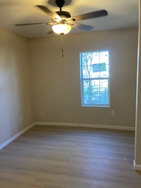 608 Turner Street Waco, TX 76704 - Photo 10 of 14 wooden floor in an empty room with a window