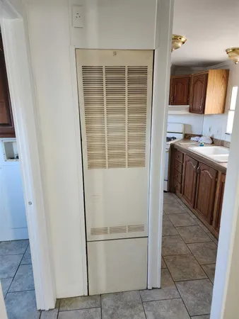 a kitchen with a refrigerator a stove top oven and cabinets