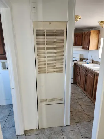 a kitchen with a refrigerator a stove top oven and cabinets