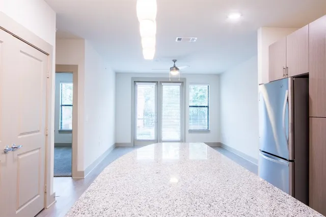 a view of a kitchen with a refrigerator cabinets and a wooden floor