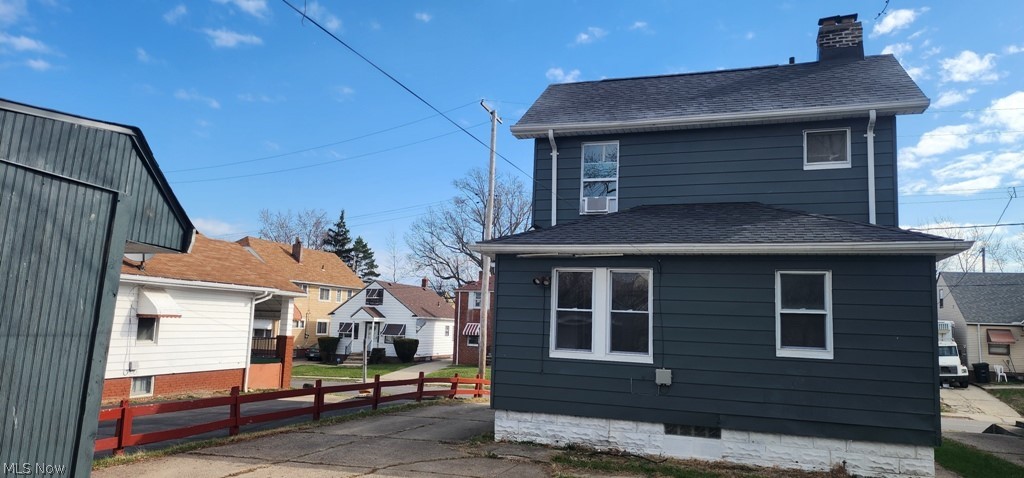 1514 Clermont Road Cleveland, OH 44110 - Photo 14 of 16 Rear view of property with a chimney and a shingled roof