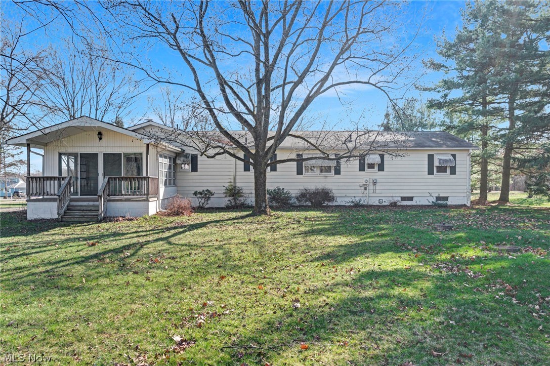 6452 Carsten Road Medina, OH 44256 - Photo 34 of 41 Rear view of house featuring a yard and a wooden deck
