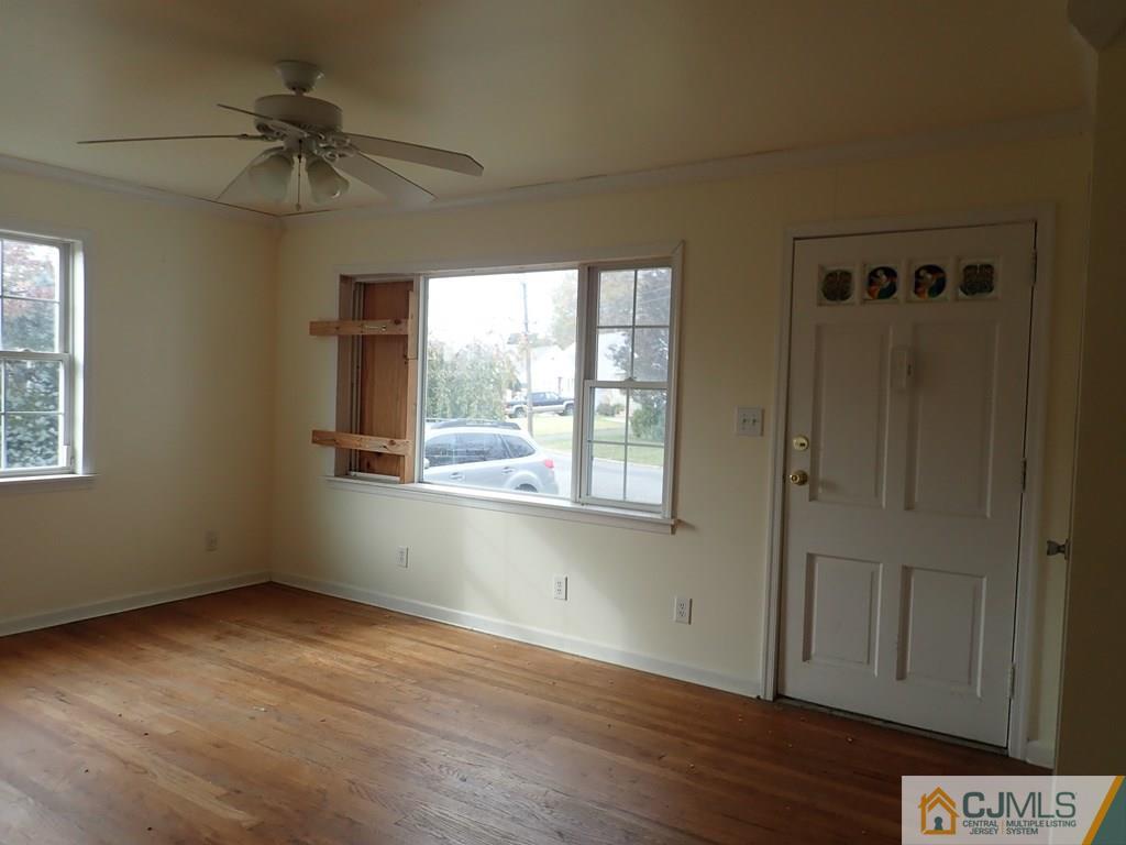25 Hull Drive Edison, NJ 08817 - Photo 4 of 11 a view of an empty room with a window and wooden floor