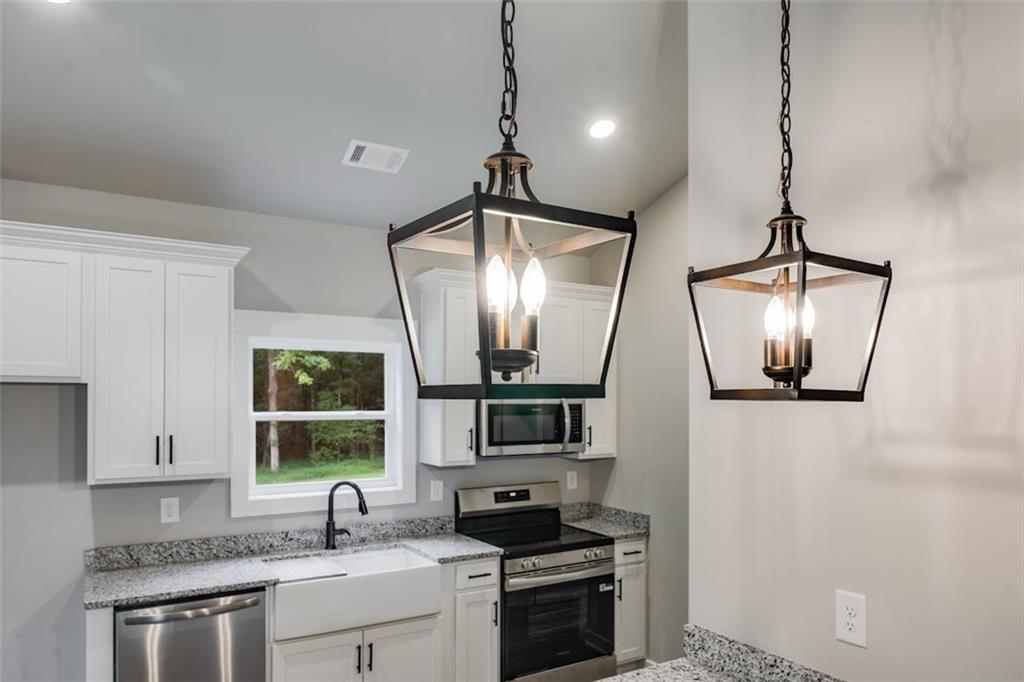 342 Dandy Road Dallas, GA 30132 - Photo 15 of 35 a kitchen with stainless steel appliances a stove sink and microwave