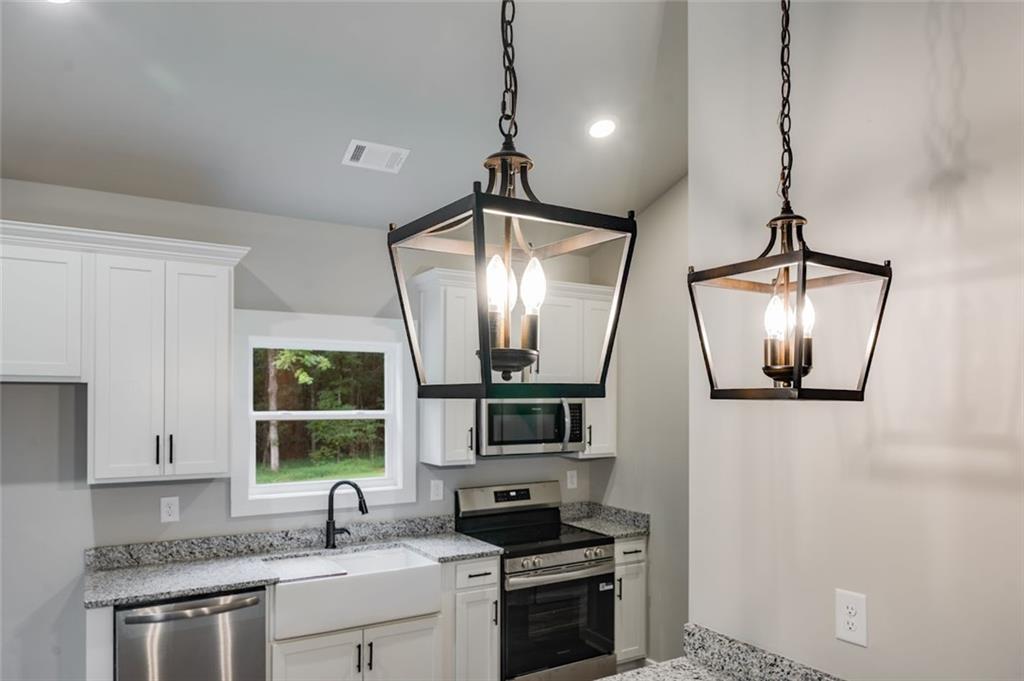 342 Dandy Road Dallas, GA 30132 - Photo 18 of 35 a kitchen with stainless steel appliances a stove sink and microwave
