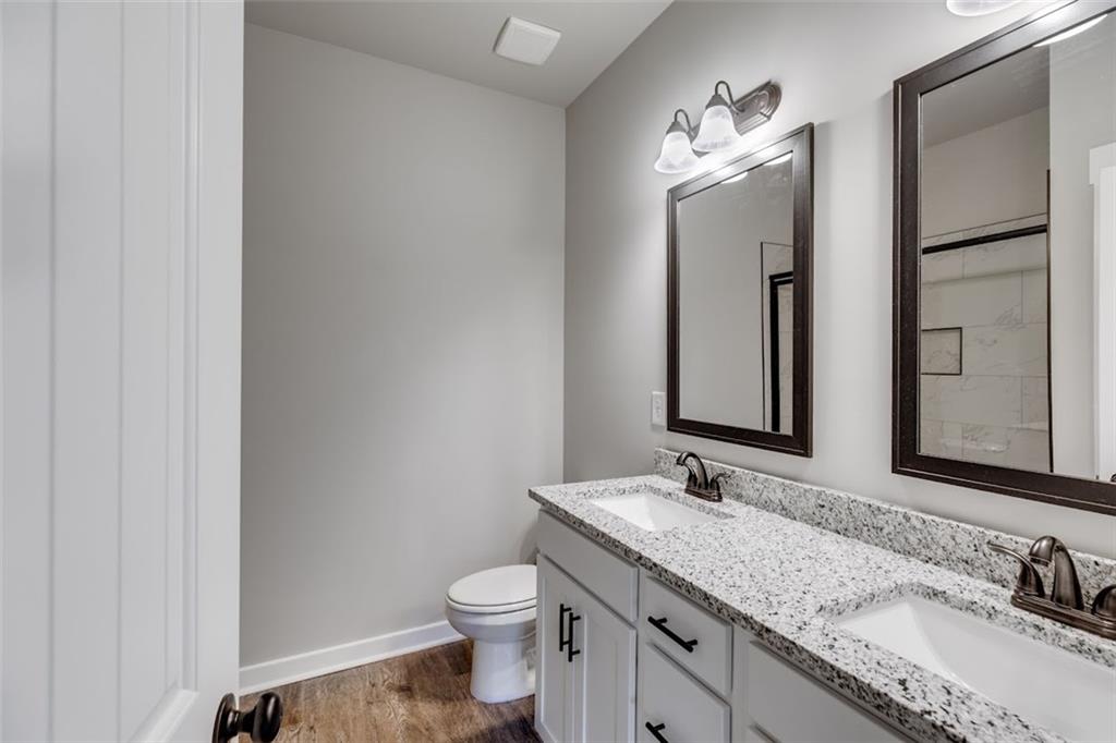 342 Dandy Road Dallas, GA 30132 - Photo 24 of 35 a bathroom with a granite countertop sink toilet and mirror