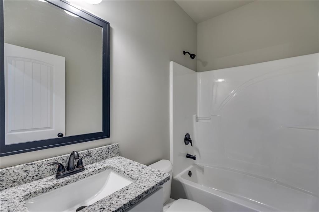 342 Dandy Road Dallas, GA 30132 - Photo 32 of 35 a bathroom with a granite countertop sink and a mirror