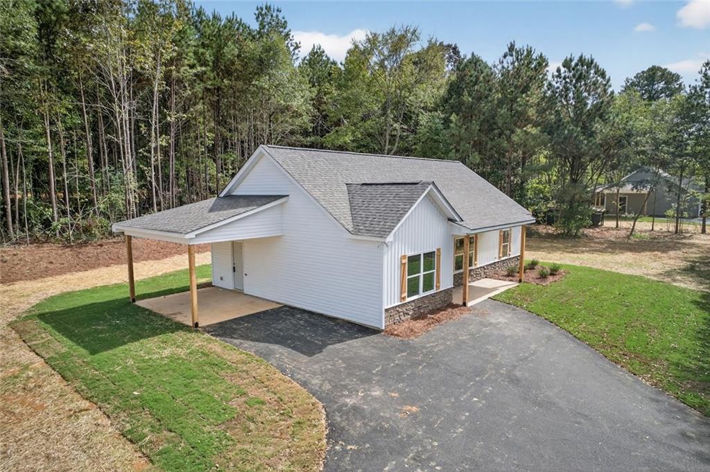 342 Dandy Road Dallas, GA 30132 - Photo 10 of 35 a front view of a house with a garden and trees