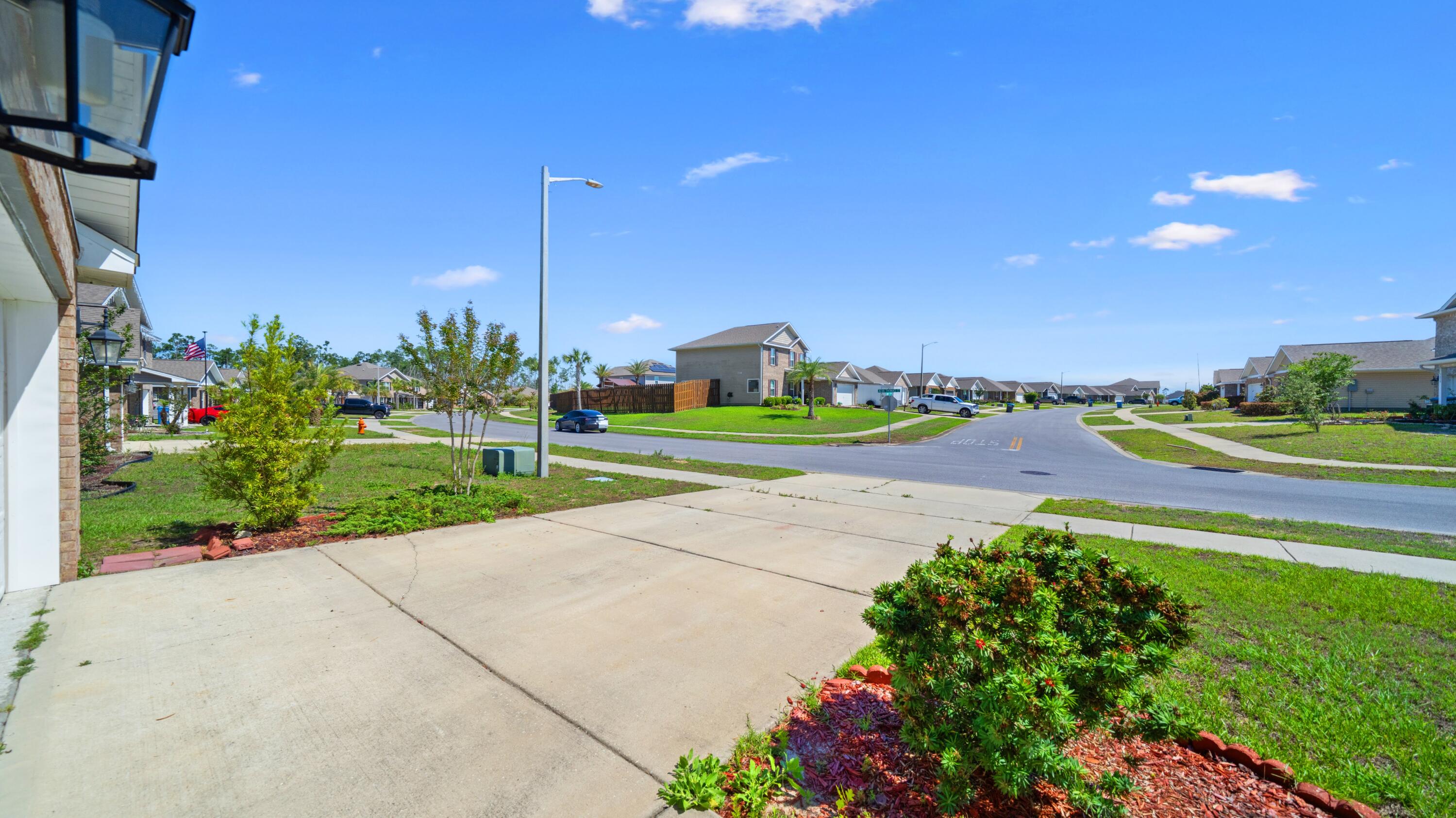 3927 Alva Thomas Road Panama City, FL 32404 - Photo 35 of 46 a view of a garden with a building in the background