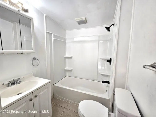 a bathroom with a sink toilet and bathtub