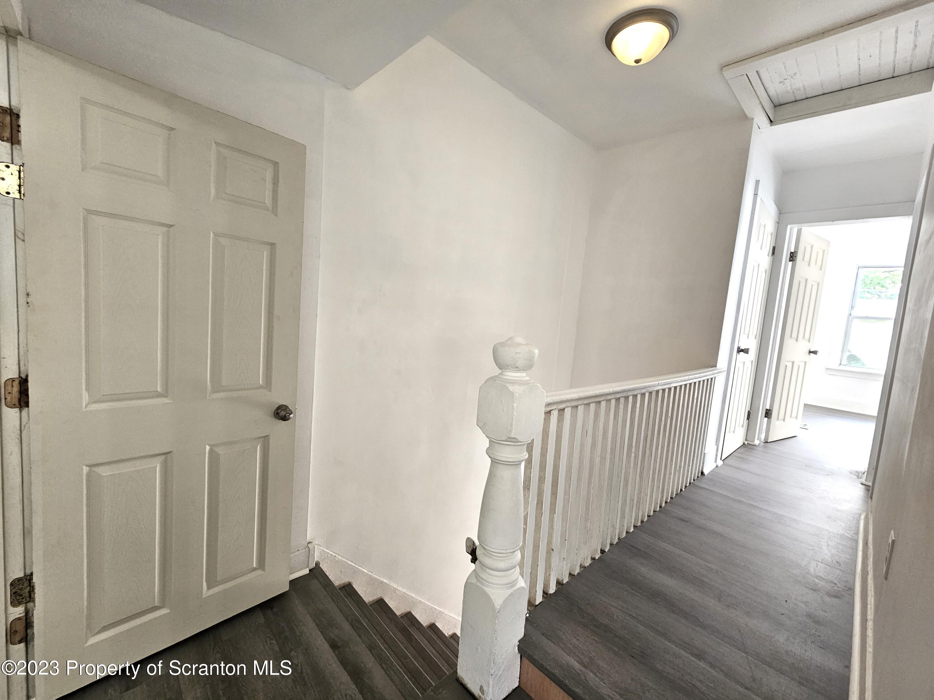 905 Green Ridge Street Scranton, PA 18509 - Photo 10 of 11 a view of a hallway with wooden floor and entryway