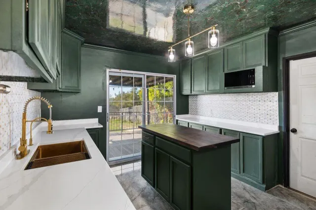 a kitchen with a sink and a refrigerator