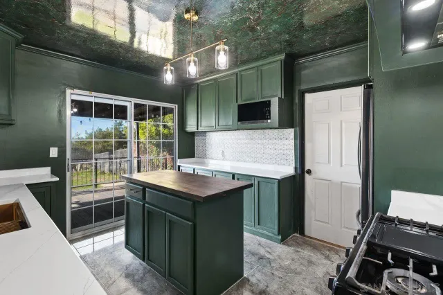 a kitchen with a sink stove and refrigerator