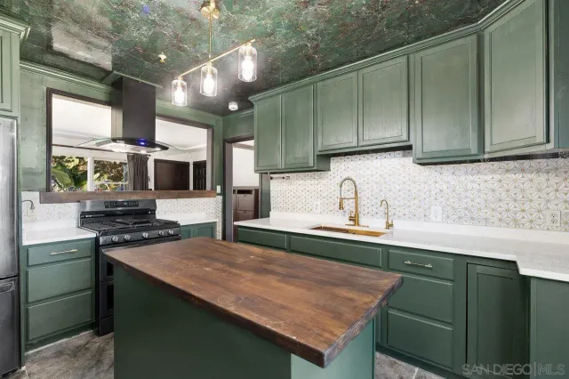 a kitchen with stainless steel appliances granite countertop a sink stove and cabinets