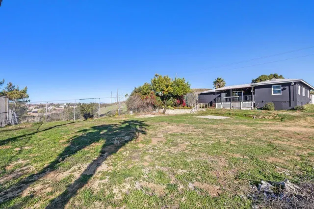 a view of a house with a yard and sitting area