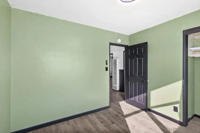 a view of hallway with wooden floor