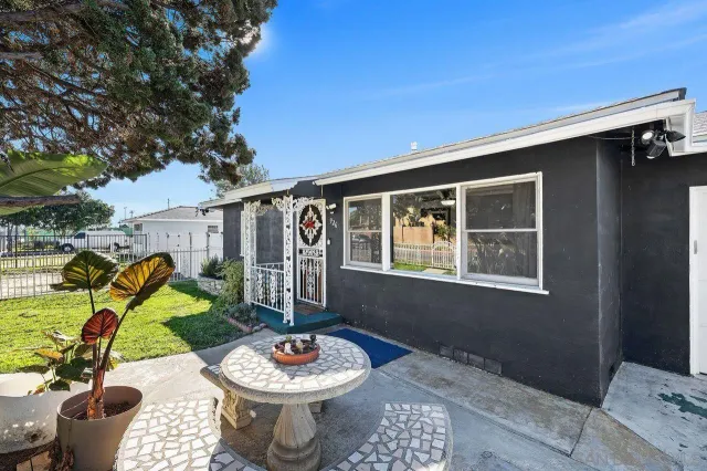 a view of a patio with table and chairs and potted plants